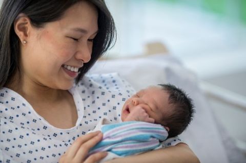 mother and newborn in hospital bed